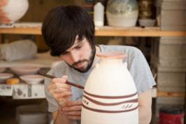 J. Eric Simmons working on a ceramic vessel